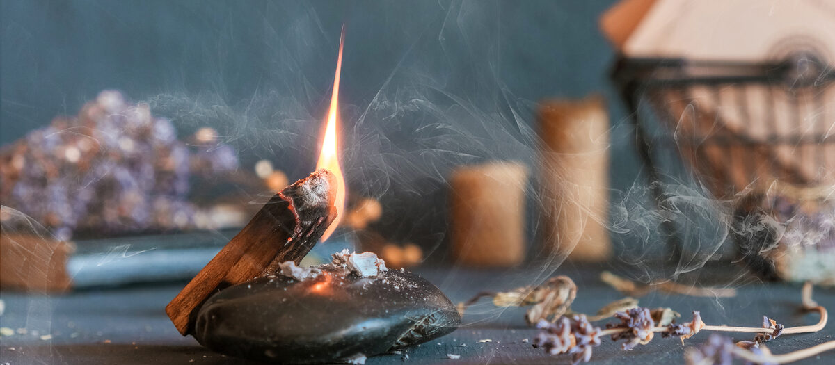 Burning palo santo with lavender and crystals